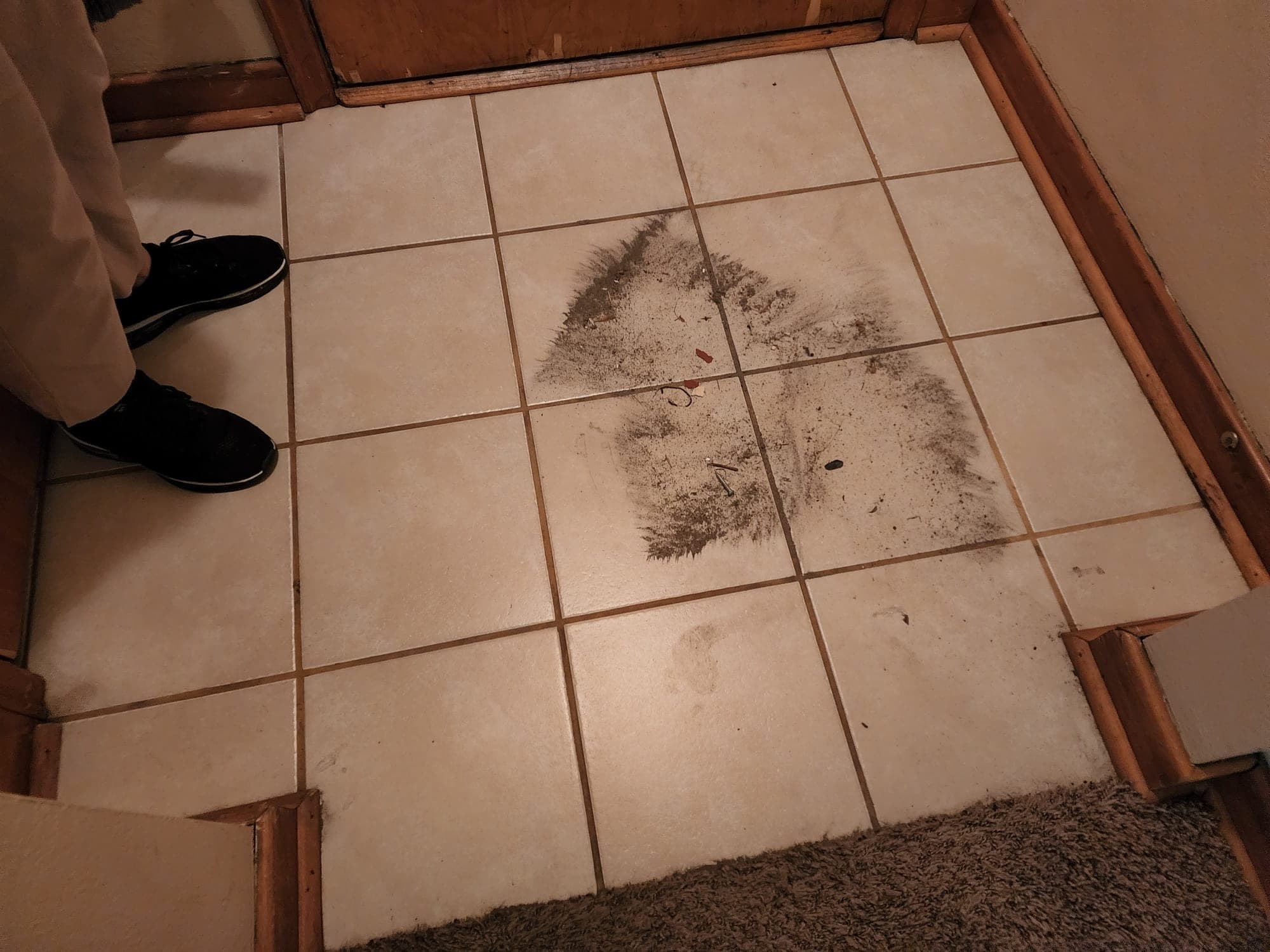 Commercial tile floor with heavy staining before cleaning