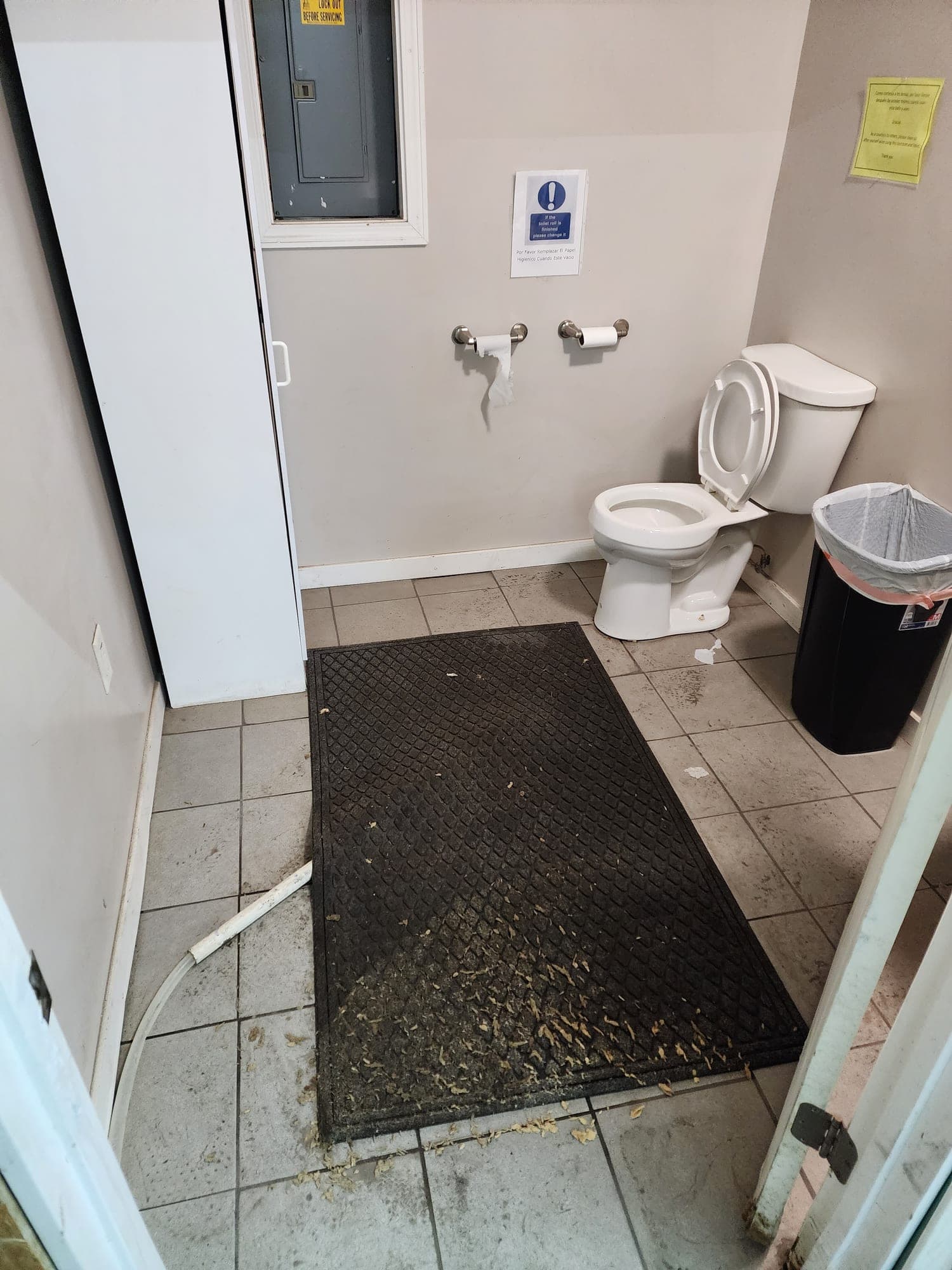 Restroom floor with debris before cleaning